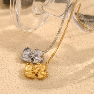 Detailed view of 18K gold and silver vintage floral pendants with textured petals