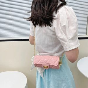 Pink quilted cylinder crossbody bag with golden chain and pearl detail for women