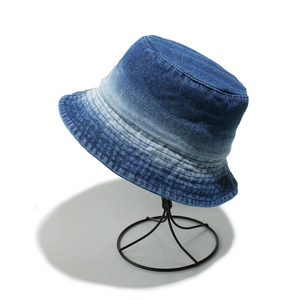Detail of vintage washed denim bucket hat with gradient blue tones and reinforced stitching