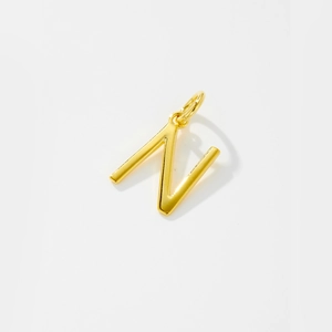 Detailed view of a gold-plated letter N pendant necklace with polished finish