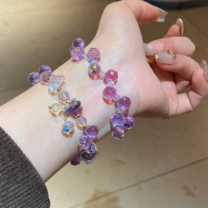 Macro shot of irregular faceted purple crystal beaded bracelet with gold metal accents