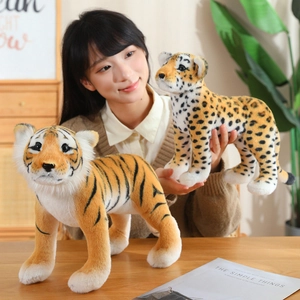 Realistic tiger and leopard plush toys held by a model in a cozy home setting