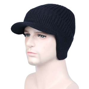 Detail of black winter knit hat with ear flaps and visor worn by a male model
