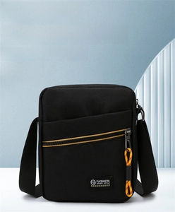 Detail of black crossbody bag featuring yellow zipper trim and fashion sport style label