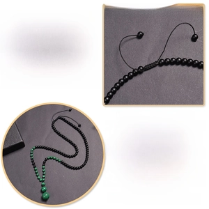 Adjustable 26-32 inch braided necklace featuring natural malachite and black stone beads