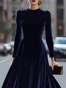 Detail of premium navy velvet dress with long sleeves and high neckline for a refined look