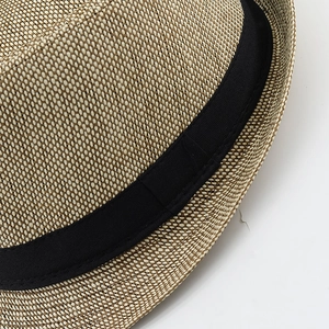 Close-up of vintage brown fedora with fine cross-weave texture and black ribbon band