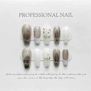 Press-on nail set featuring coffee brown marble and gold line designs on long coffin nails