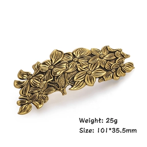 Detailed macro view of vintage bronze flower hair clip with size 101x35.5mm and 25g weight