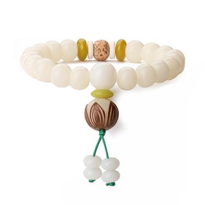 Detailed shot of Bodhi root beads bracelet with lotus charm and green woven knot