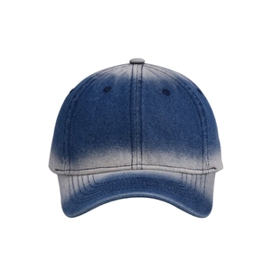 Detail view of the stitching on a blue and white gradient washed denim baseball cap