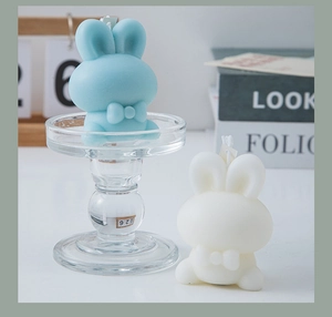 Detailed view of cute blue and white rabbit candles on a minimalist desk setting