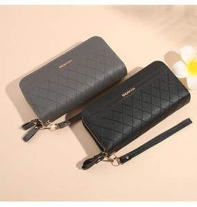 Detail view of long PU leather wallets with diamond quilt texture and wrist straps