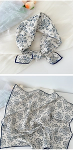 Close-up of elegant paisley pattern printed on soft silk-like linen small square neck scarf