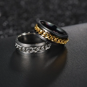 Macro detail of spinning chain rings in silver and black-gold stainless steel finish
