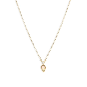 Close-up of a gold teardrop opal pendant with a sparkling diamond accent on a fine chain