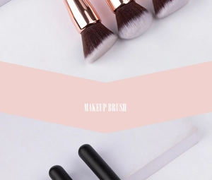 Detail of professional makeup brush with rose gold ferrule and dual-tone synthetic bristles