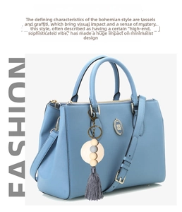 Detail of light blue lychee pattern bag with wooden beads and grey tassel pendant