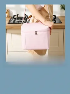 Pink insulated lunch bag with top handle and adjustable shoulder strap for picnics