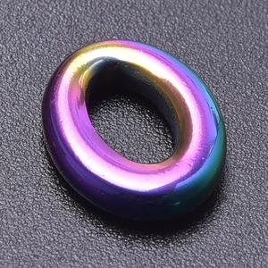 Macro detail of oval stainless steel jewelry part with vibrant rainbow iridescent finish