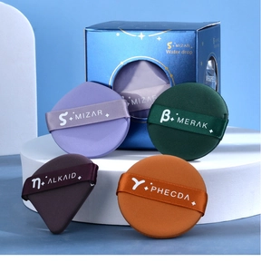 Detailed view of colorful assorted makeup sponges in various shapes on a white platform