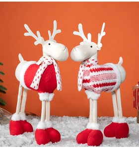 Detailed view of plush Christmas reindeer dolls in red and white festive knitwear