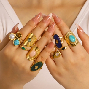 Vintage gold plated stainless steel ring set with natural gemstones worn by a model
