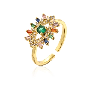 Detail of 18K gold plated evil eye ring featuring a green zircon and colorful gemstones