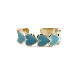 Detail of gold-plated open ring featuring a continuous light blue enamel heart pattern