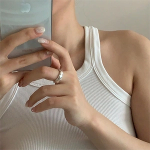 Close-up of geometric S925 sterling silver ring with triangular facets on finger