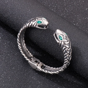 Vintage stainless steel open bangle with double snake heads and green gemstones