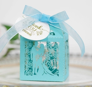 Detail of light blue laser cut wedding favor box with Mr & Mrs text and thank you tag