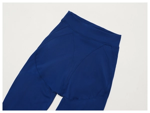 Detail of high-waisted deep blue yoga pants with ergonomic V-shaped booty lifting seams