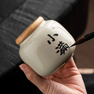 Ceramic mini tea canister with wooden lid and Xiaoman calligraphy design