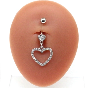 Detail of silver heart-shaped belly ring with crystals on human model mannequin