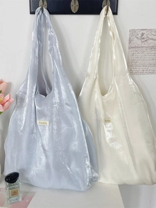 Metallic pleated tote bags in silver blue and off-white with Sezakka label detail
