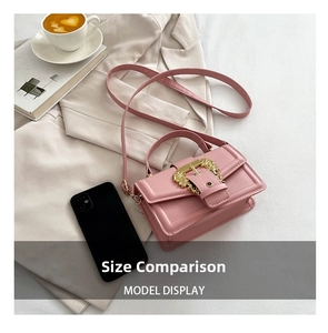 Pink mini crossbody bag with baroque gold buckle shown next to a smartphone for scale