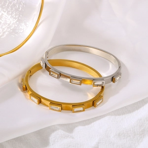 Luxe 18k gold and silver stainless steel bangles with inlaid zircon on white silk