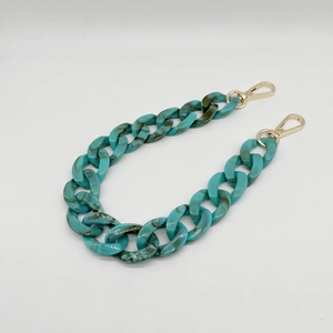 Detail of teal marbled acrylic chain link with shiny gold metal lobster clasps