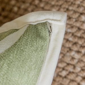 Green corduroy and beige plush pillow cover featuring a hidden zipper detail