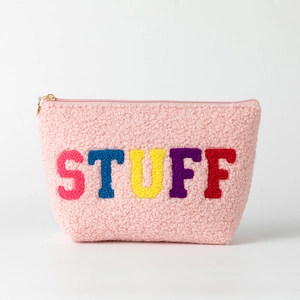 Detail of pink fleece makeup bag featuring colorful chenille STUFF letter patches