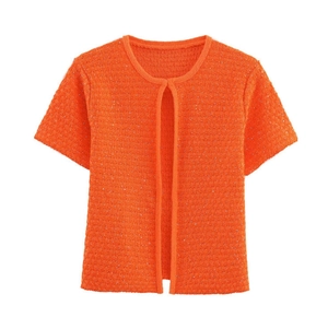 Detail of orange short-sleeve knit cardigan with subtle shimmer and crew neckline