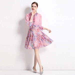 Pink floral chiffon dress with lantern sleeves and gathered waist in a full studio shot
