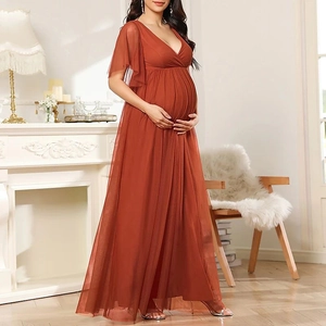 Caramel V-neck maternity tulle gown with high waist and short sleeves in an elegant room