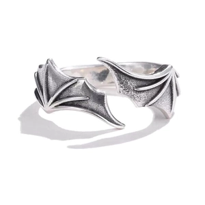Detailed macro view of retro silver devil wing ring with intricate oxidized metal texture