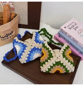 Detailed crochet texture of sunflower pattern bags with elegant pearl buckle closure