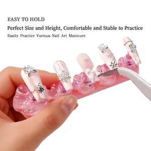 Cat claw nail art practice stand with aurora pink base and rhinestone bow press-on nails