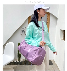 Detail view of purple waterproof fitness bag with shoe compartment and sturdy shoulder strap