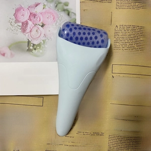 Close-up of facial ice roller with textured blue cooling head and ergonomic handle
