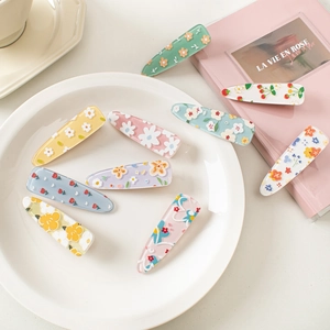 Set of cute acrylic flower and cherry hair clips in a floral aesthetic arrangement